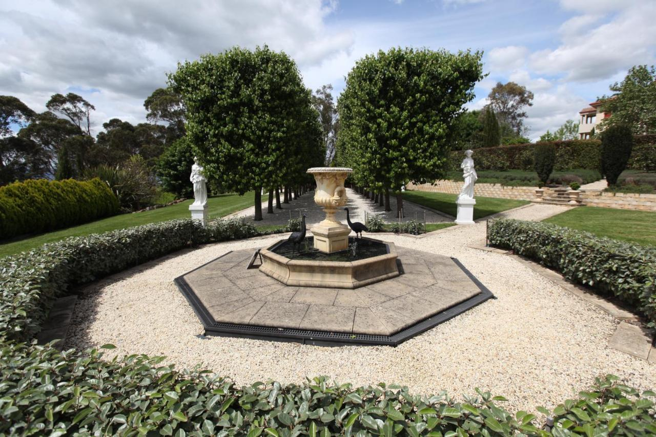 The octagonal fountain framed by clipped pear trees