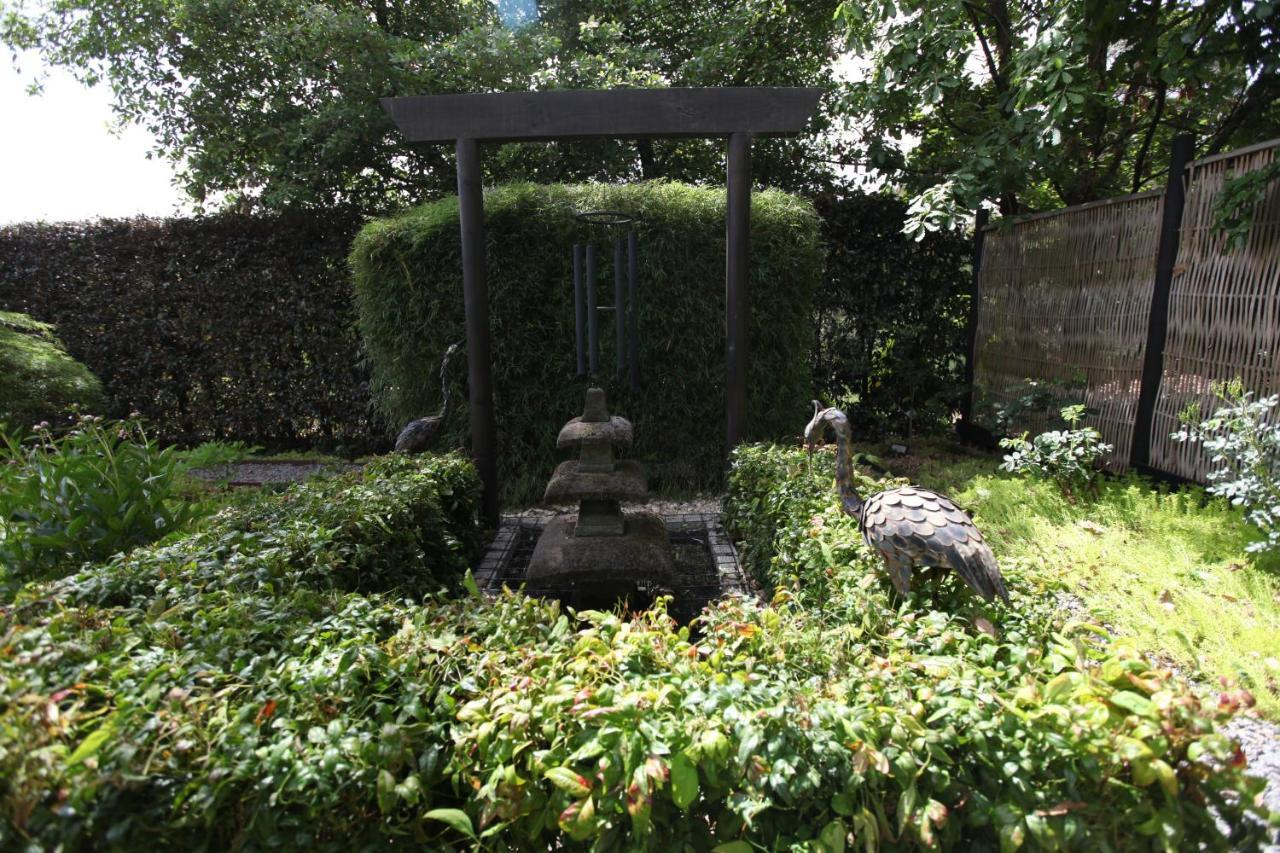 Torii gate and crane sculpture beside the garden pond