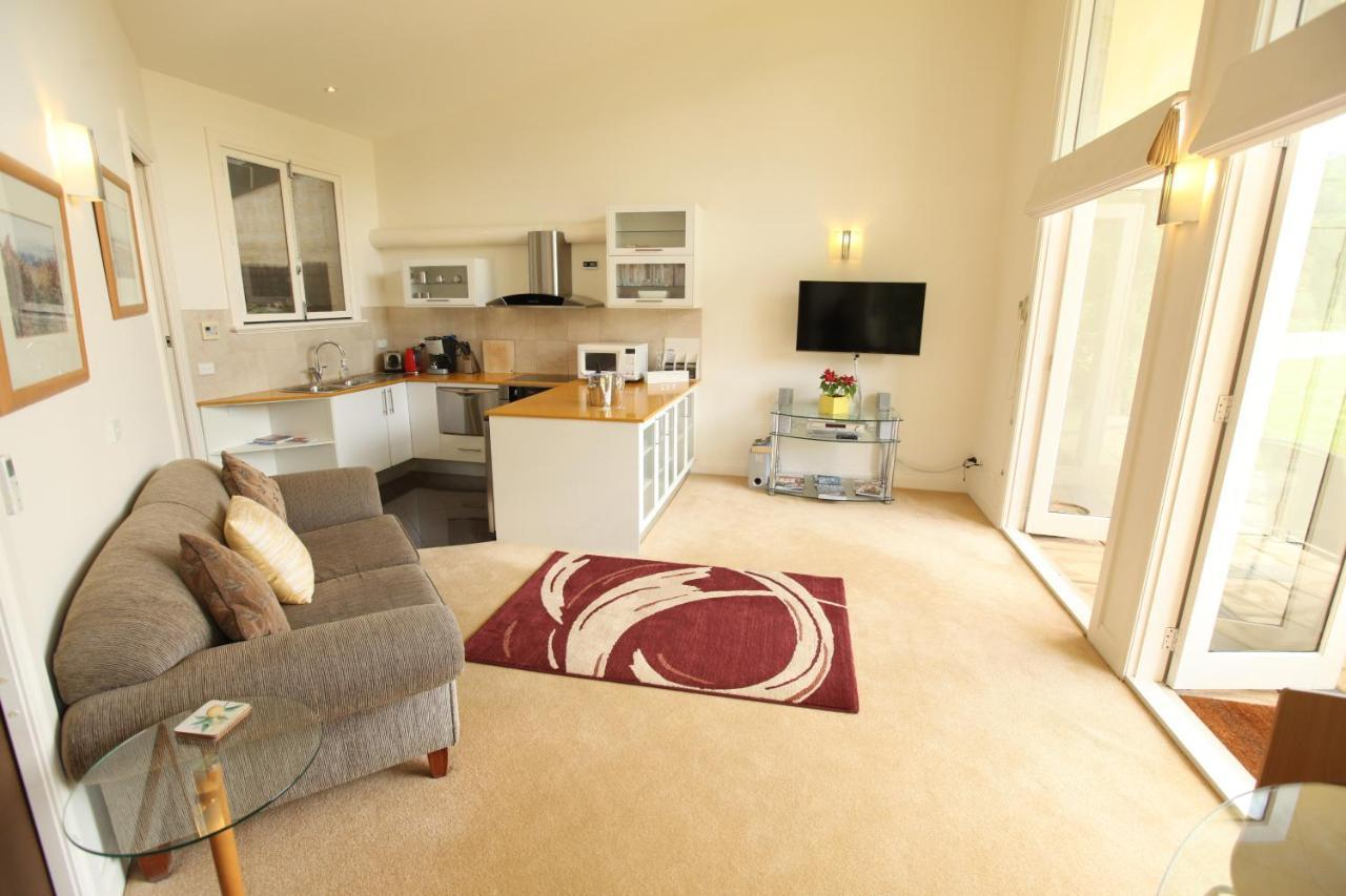 Living area and fully equipped kitchen in the Melba Suite